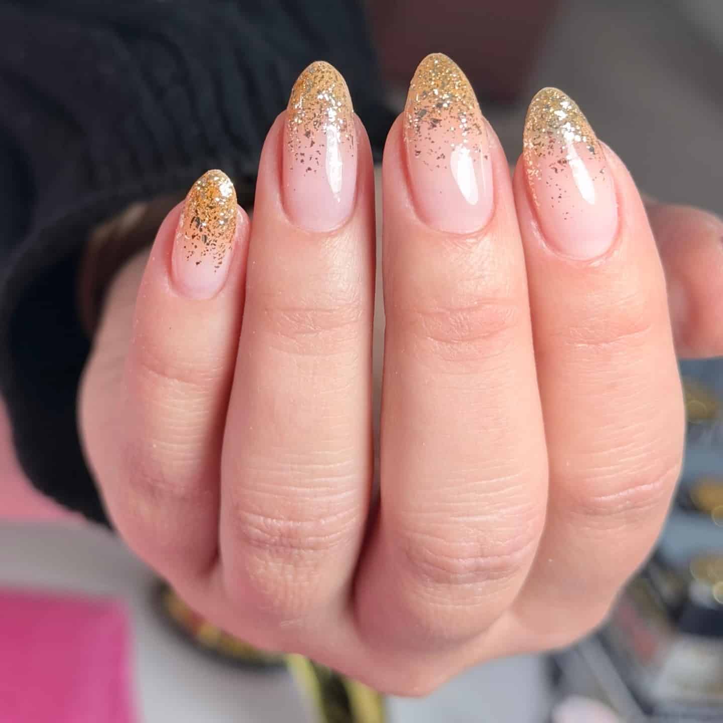 16. Gold Glitter Ombre Almond Nails - glitter sparkle nail ideas