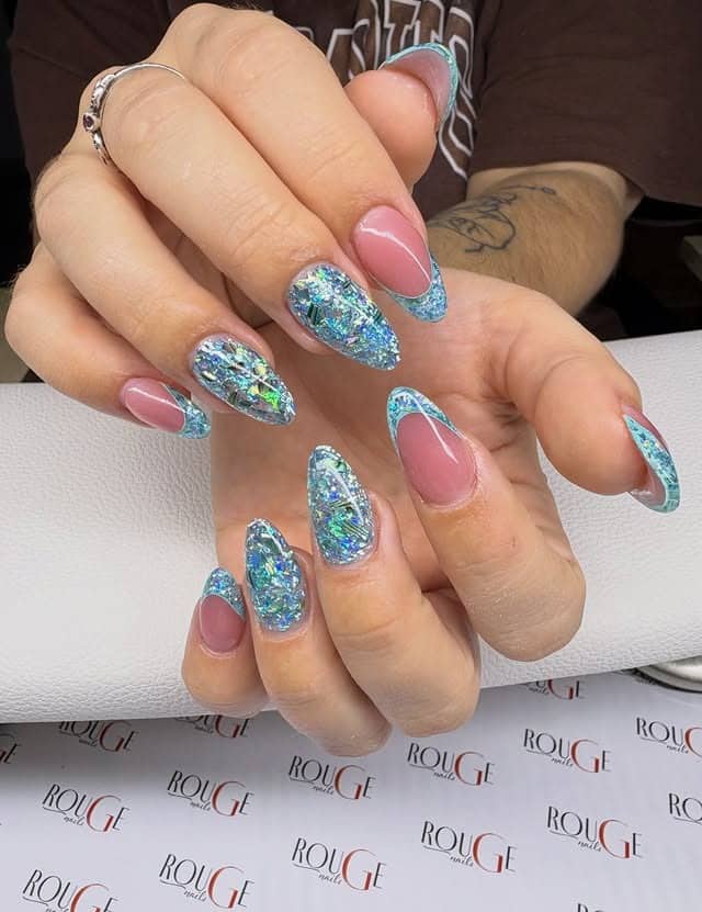 1. Icy Blue Glitter French Almond Nails - winter nail ideas
