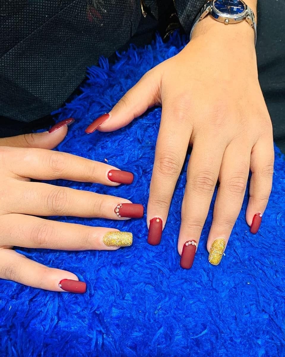 11. Matte Burgundy Coffin Nails with Gold Glitter Accents - nail ideas for work