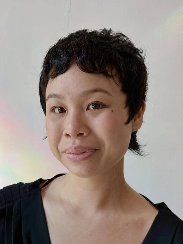16. Tousled Black Pixie with Curly Bangs - Pixie Hairstyles With Bangs