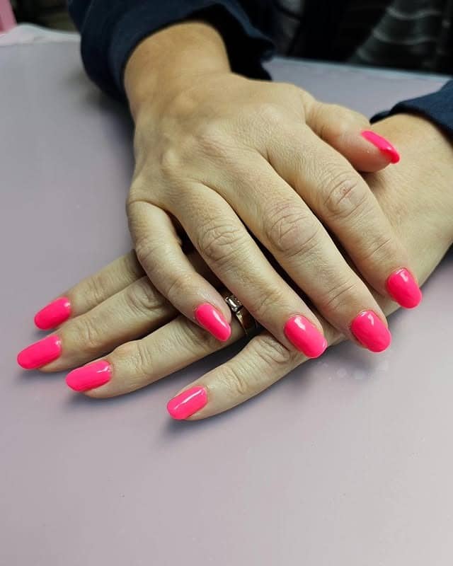 5. Neon Pink Oval Nails - solid nail color ideas 