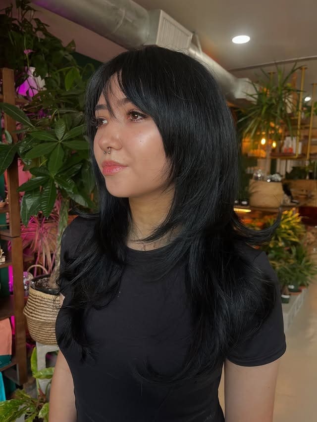 1. Jet Black Butterfly Layers with Wispy Curtain Bangs - Medium Wispy Haircuts