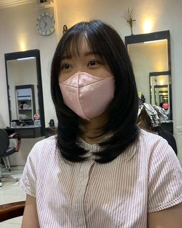 8. Glossy Black Layered Bob with Wispy Bangs - Medium Wispy Haircuts