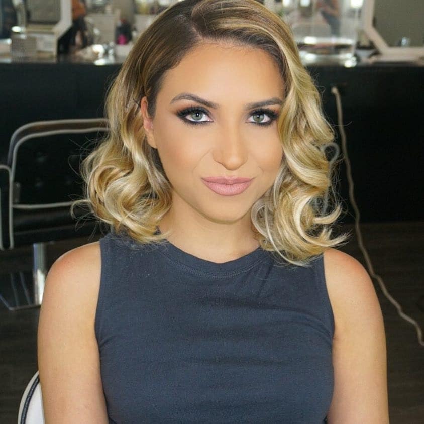 9. Golden Blonde Wavy Lob with Side Part - Medium Wispy Haircuts