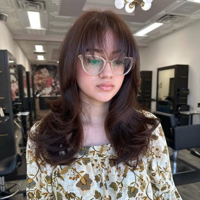 20. Chocolate Brown Feathered Layers with Wispy Bangs - Medium Wispy Haircuts