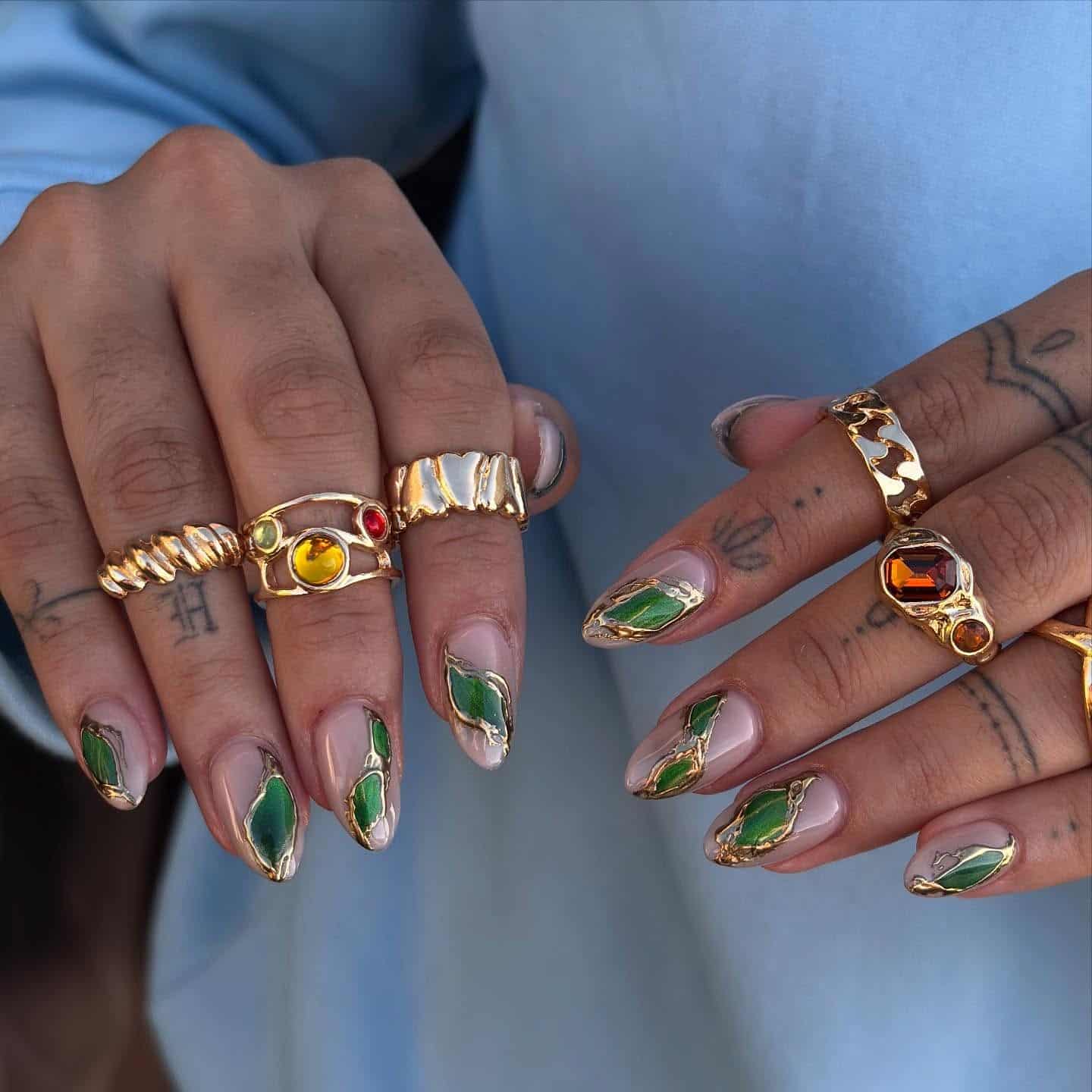 2. Emerald Stone Almond Nails with Gold Outlines - almond nail ideas