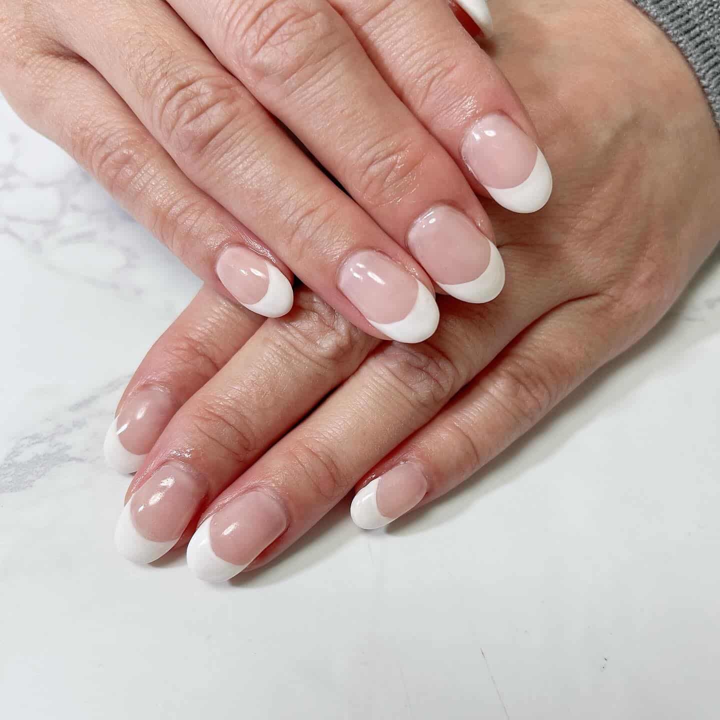 7. Classic Soft White French Nails - office nail ideas