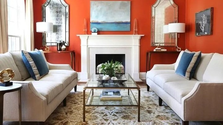 10. Vibrant Orange Living Room with Classic White Trim - orange living room ideas