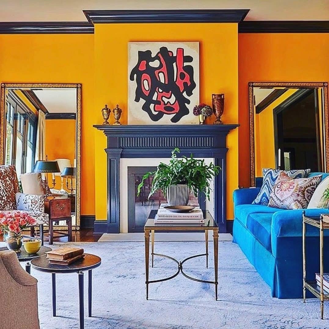 12. Bright Marigold Living Room with Bold Blue Velvet Seating - orange living room ideas