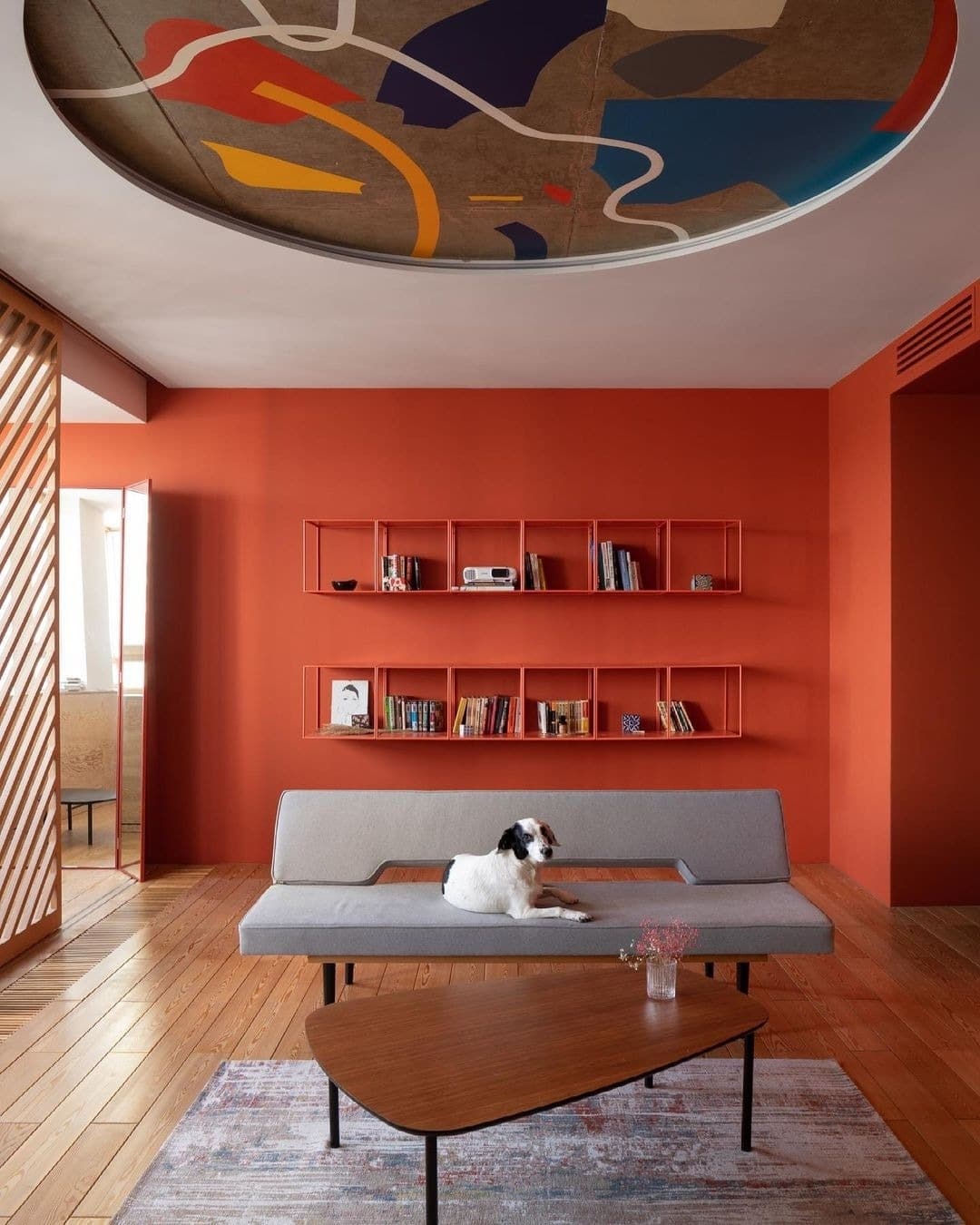 14. Burnt Orange Modern Living Room with Sculptural Ceiling Detail - orange living room ideas