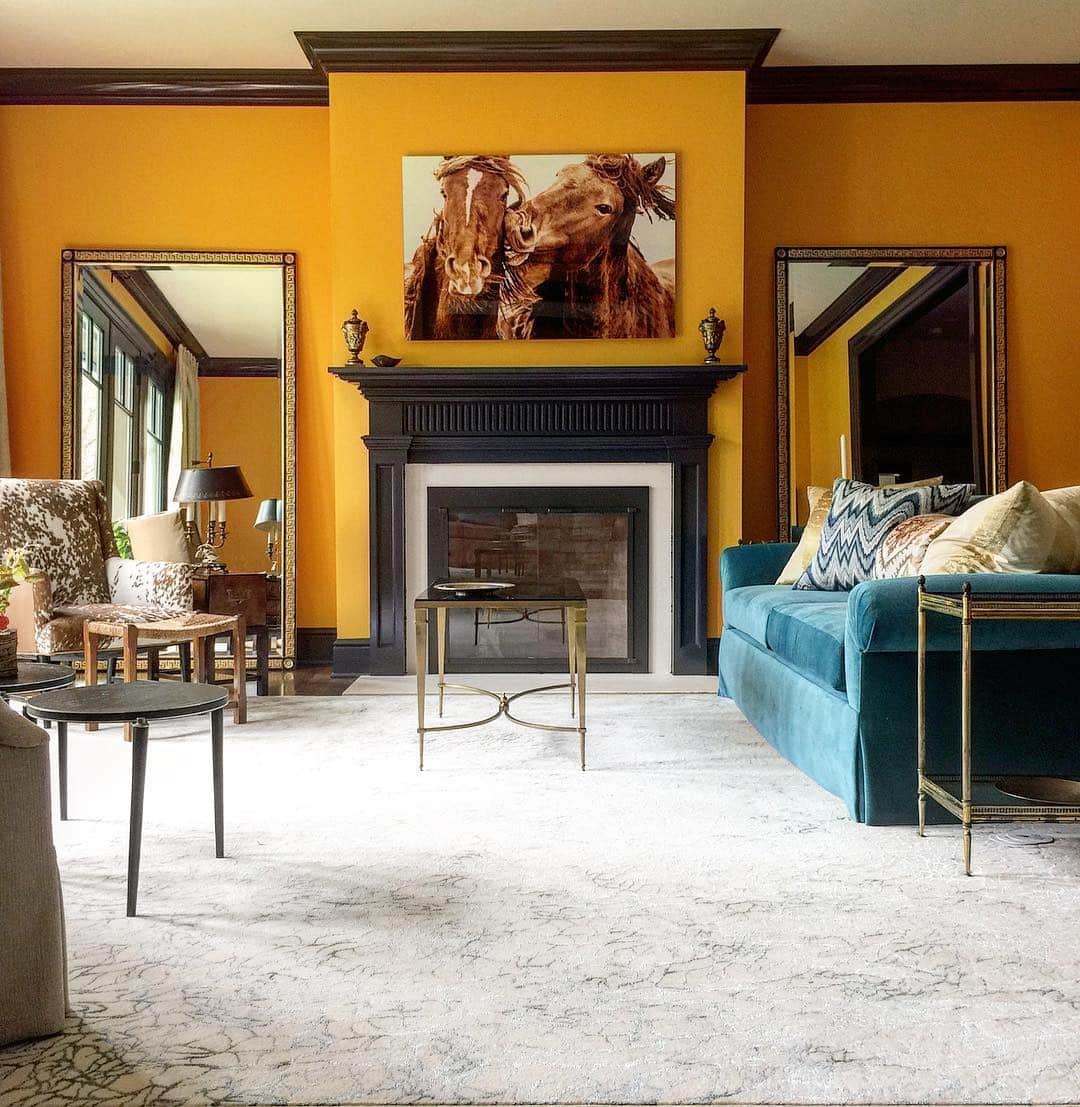 15. Golden Mustard Fireplace Wall with Eclectic Luxury Accents - orange living room ideas