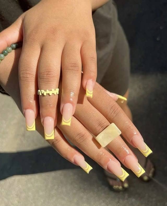 5. Retro Swirl Yellow French Tip Coffin Nails - yellow french tip nail ideas