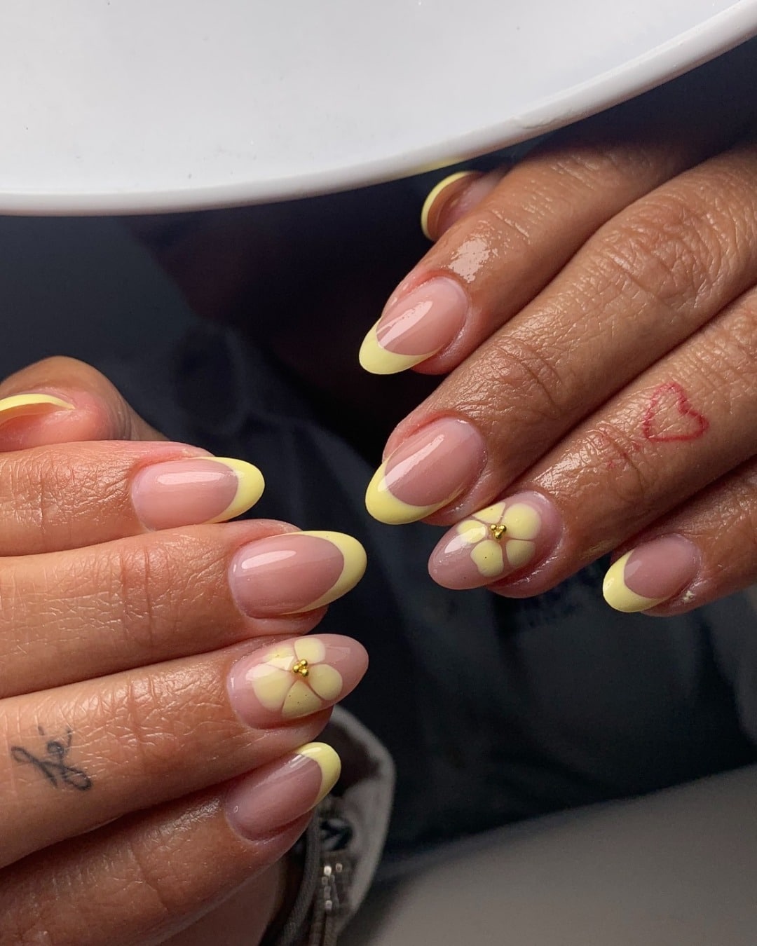11. Pastel Yellow French Tip Almond Nails with Daisy Accent - yellow french tip nail ideas