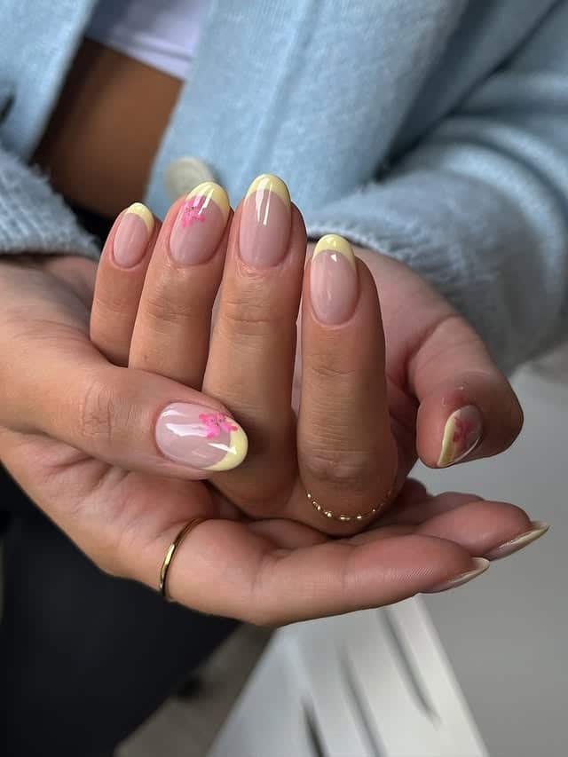 17. Yellow French Tip Almond Nails with Pink Floral Accents - yellow french tip nail ideas