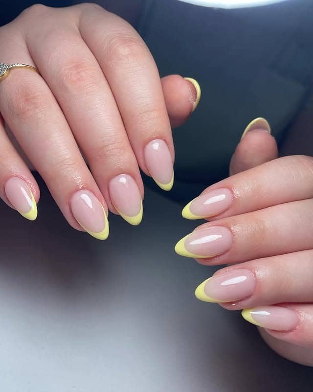 19. Glossy Yellow French Tip Almond Nails - yellow french tip nail ideas