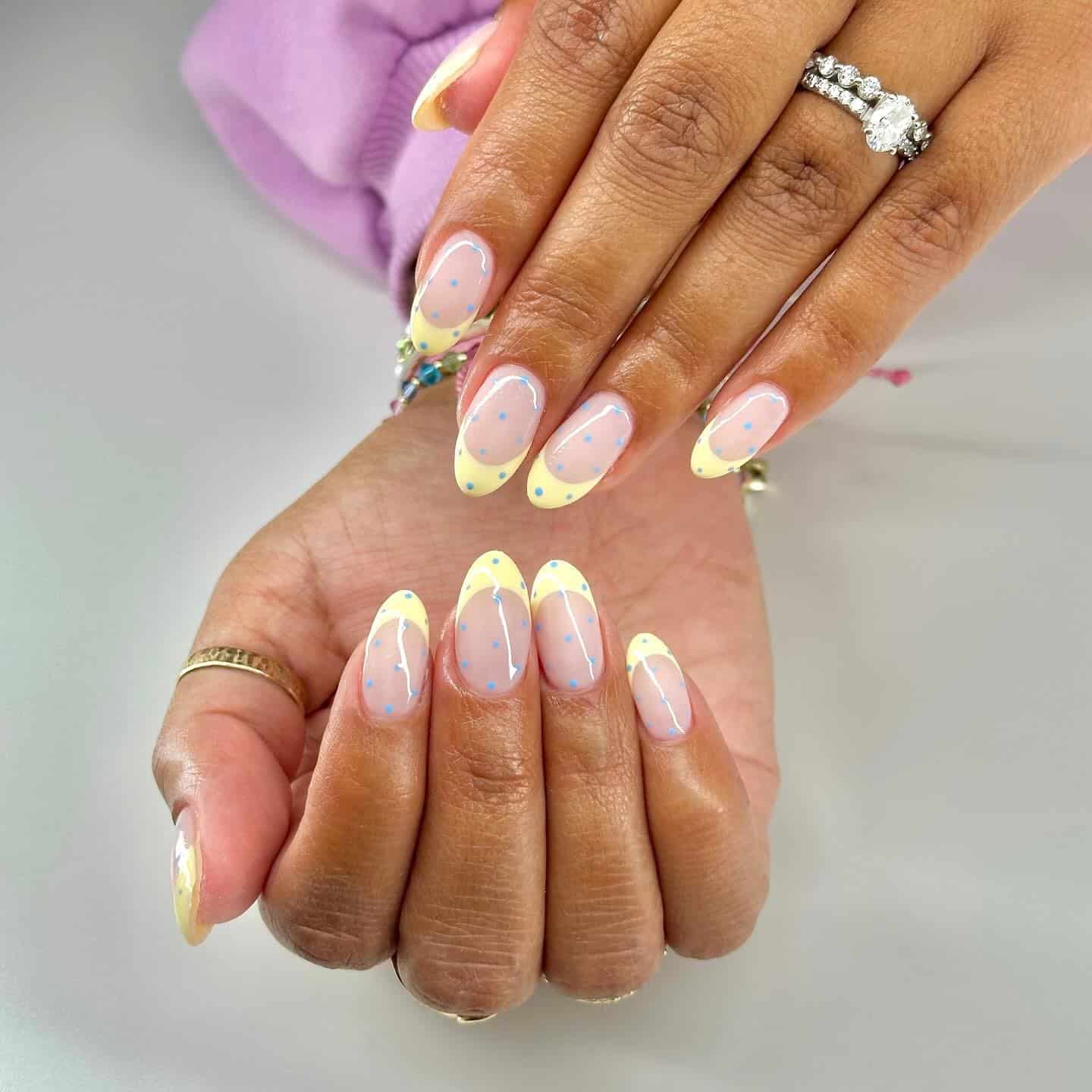 21. Pastel Yellow French Tip Almond Nails with Blue Polka Dots - yellow french tip nail ideas