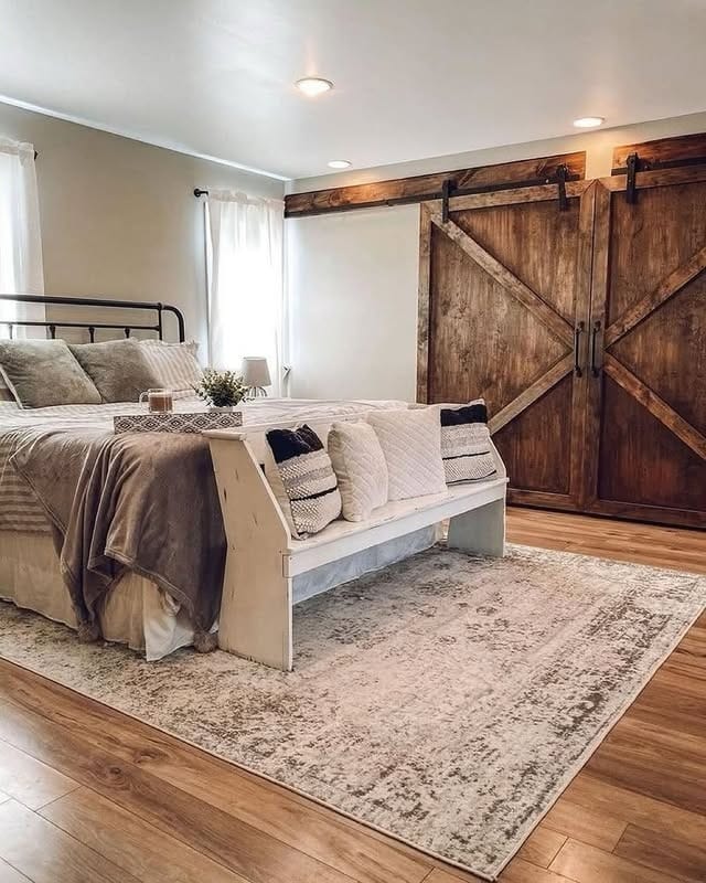 4. Rustic Barn Door Farmhouse Bedroom in Earthy Neutrals - farmhouse bedroom ideas