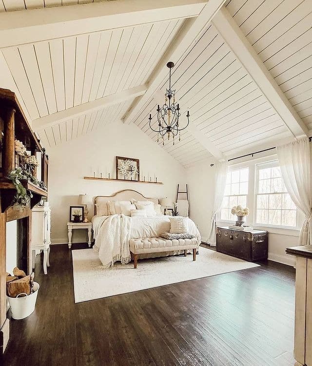 13. Vaulted White Farmhouse Bedroom with Dark Wood Floors - farmhouse bedroom ideas