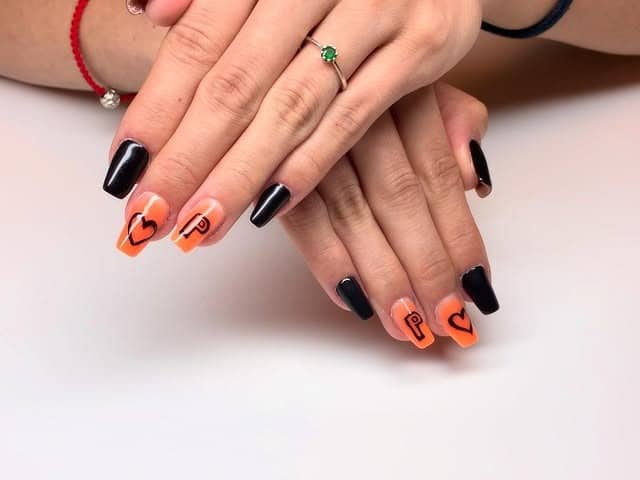 9. Black and Orange Graphic Coffin Nails - coffin nail ideas
