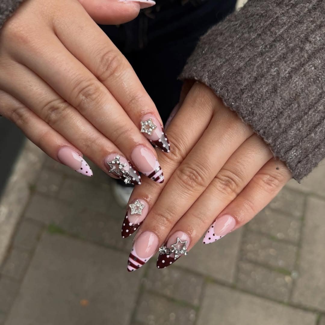 3. Chocolate Star Accent Almond Nails - winter almond nail ideas