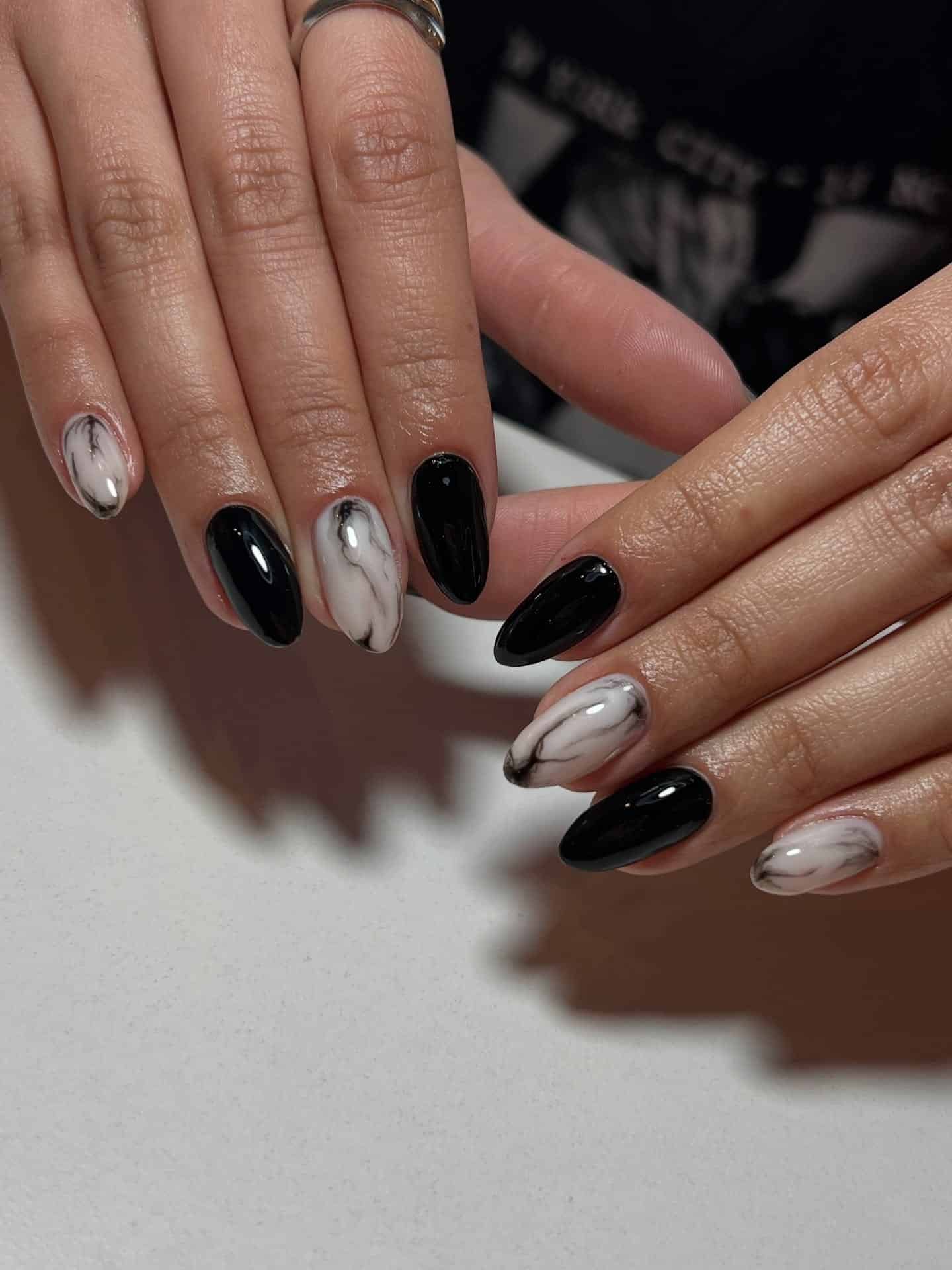10. Black Marble Almond Nails - winter almond nail ideas