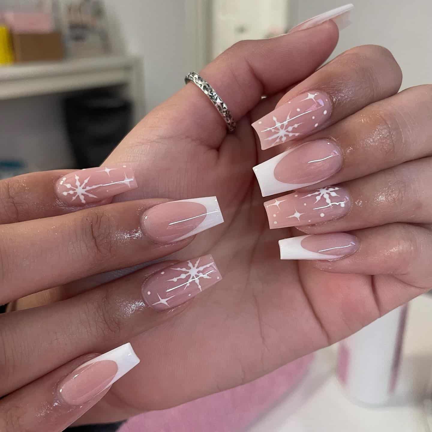 11. Snowflake French Tip Coffin Nails - winter almond nail ideas