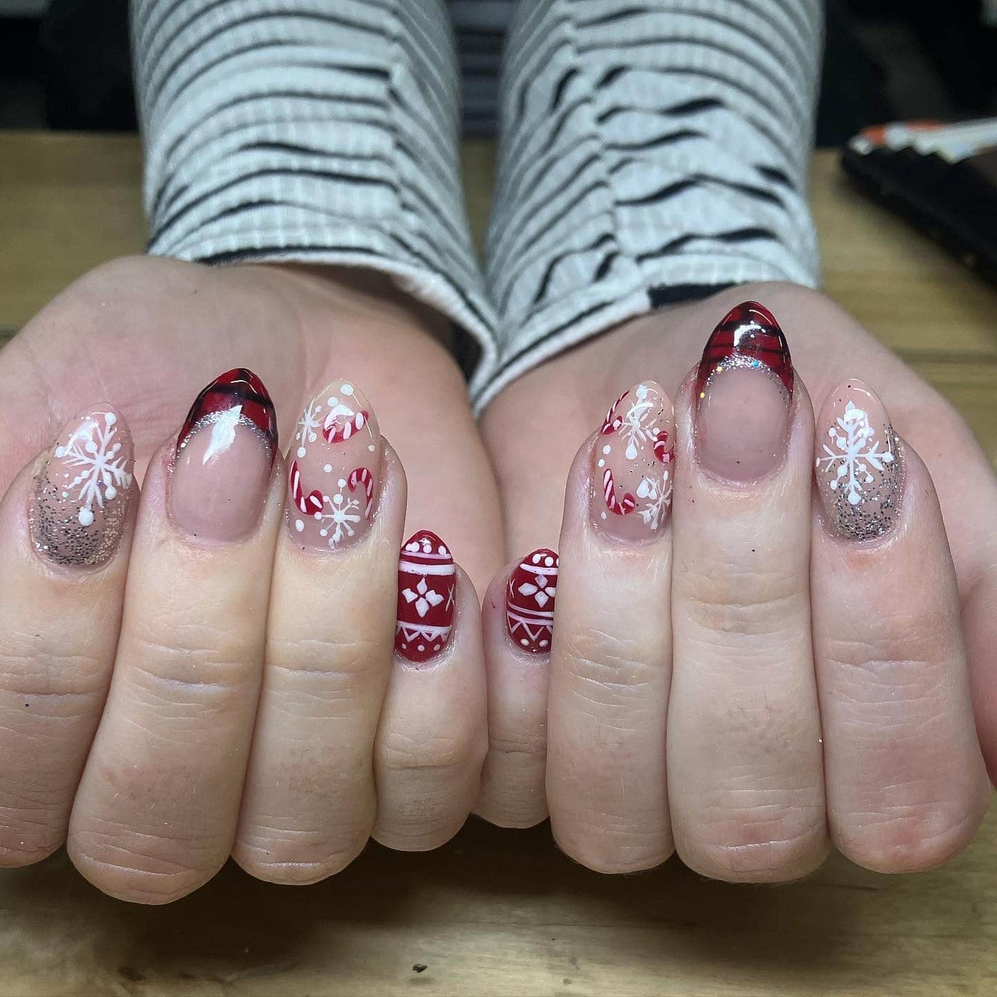 13. Candy Cane Red Winter Almond Nails - winter almond nail ideas