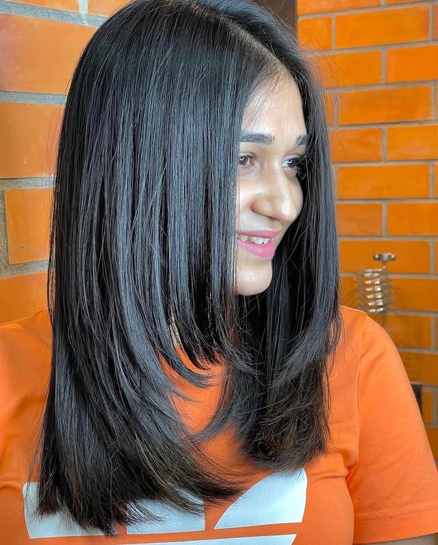 9. Sleek Feather Haircut with Midnight Black Hair - Feather Haircut