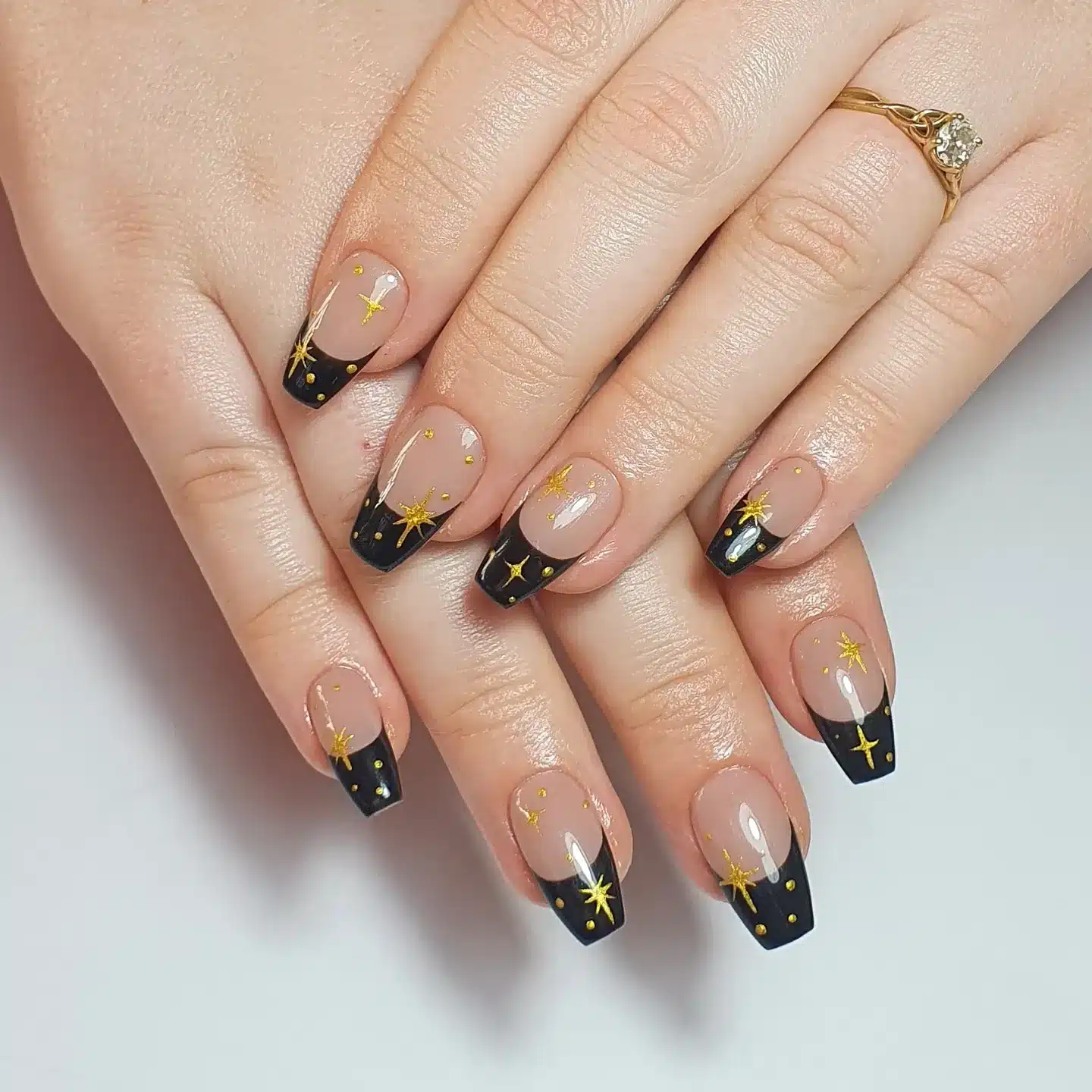 8. Black French Tips with Gold Star Nail Art - short black coffin nail ideas