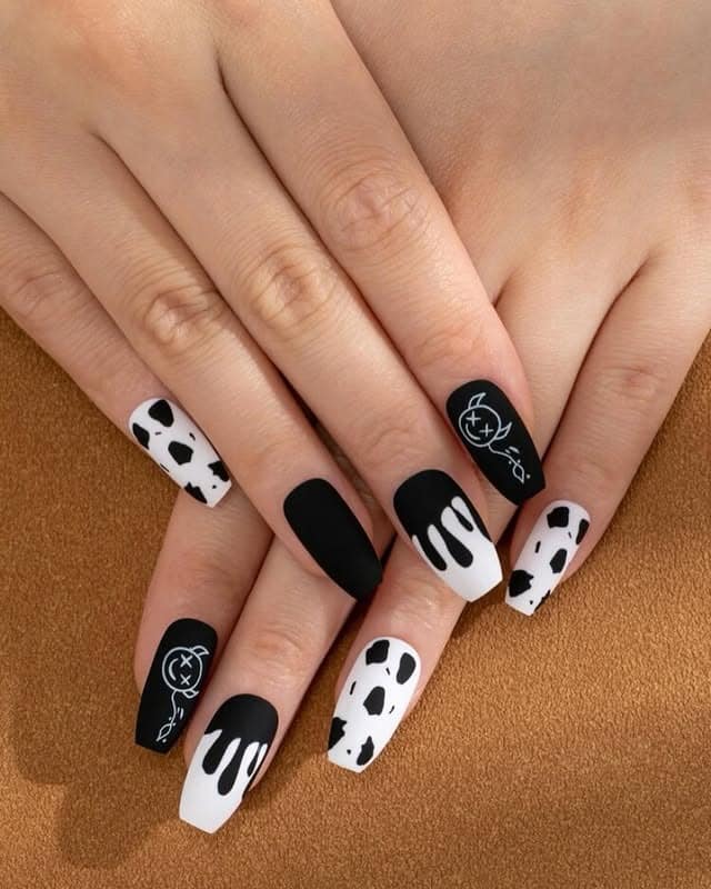 9. Black and White Cow Print Coffin Nails - short black coffin nail ideas