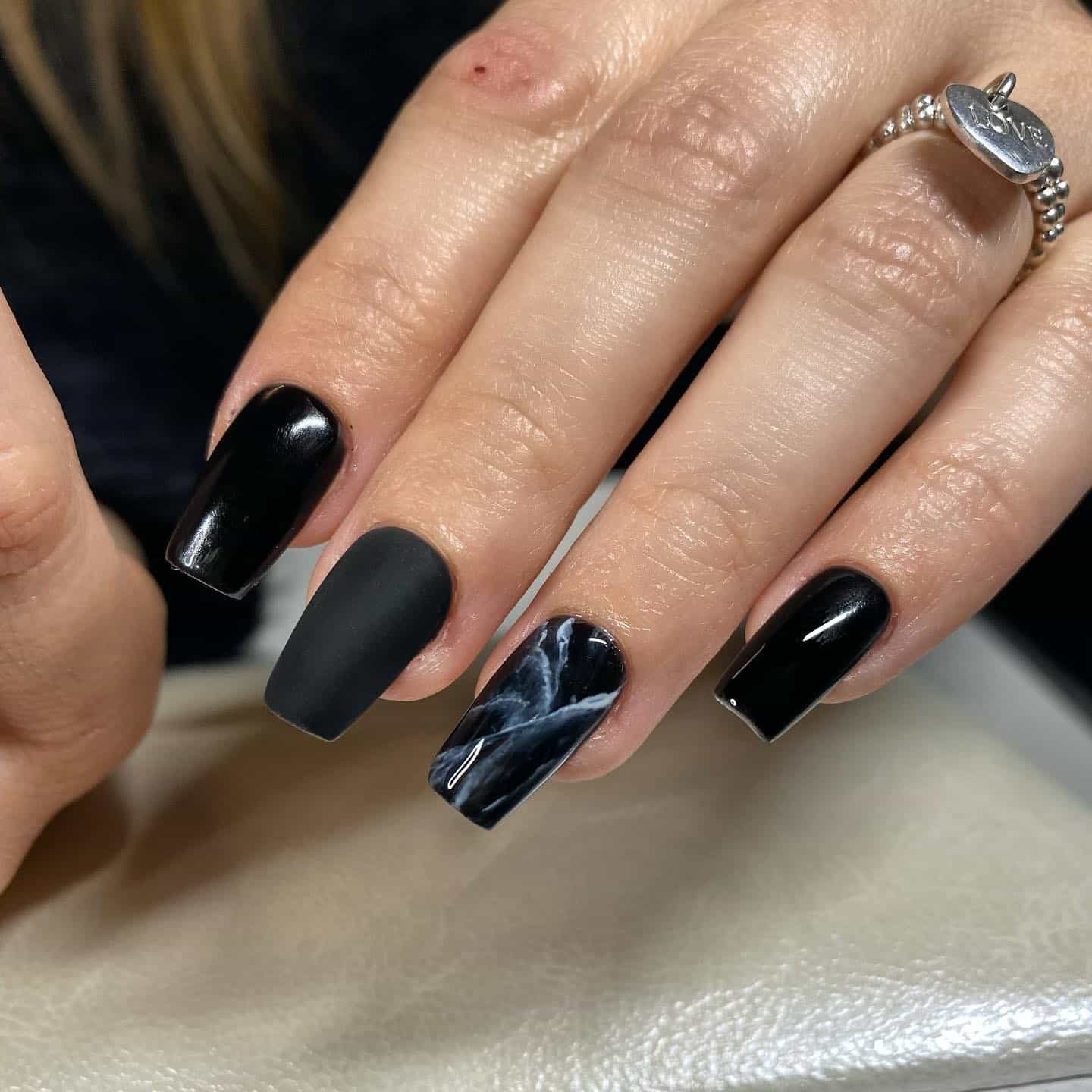 14. Matte Black Marble Accent Coffin Nails - short black coffin nail ideas