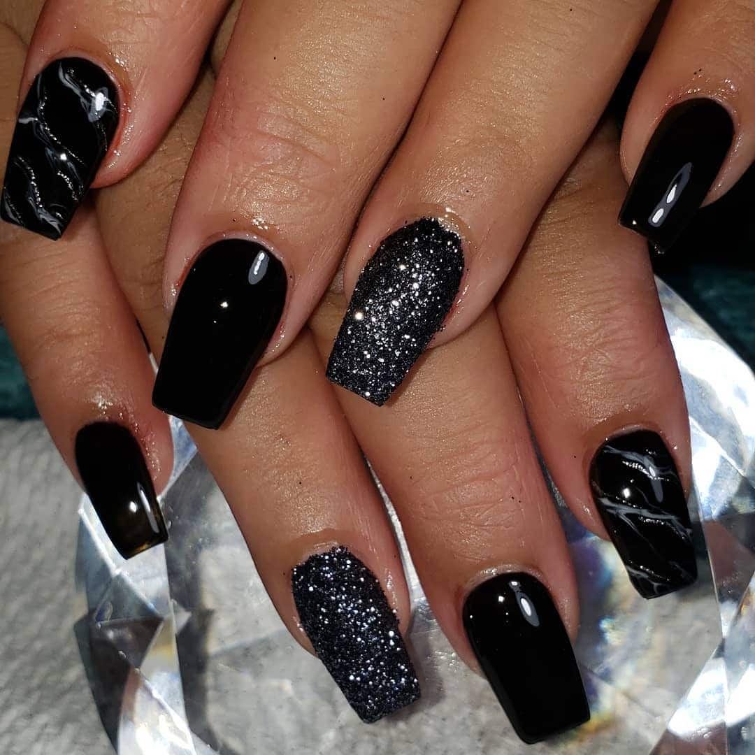22. Glossy Black Coffin Nails with Glitter Accent - short black coffin nail ideas
