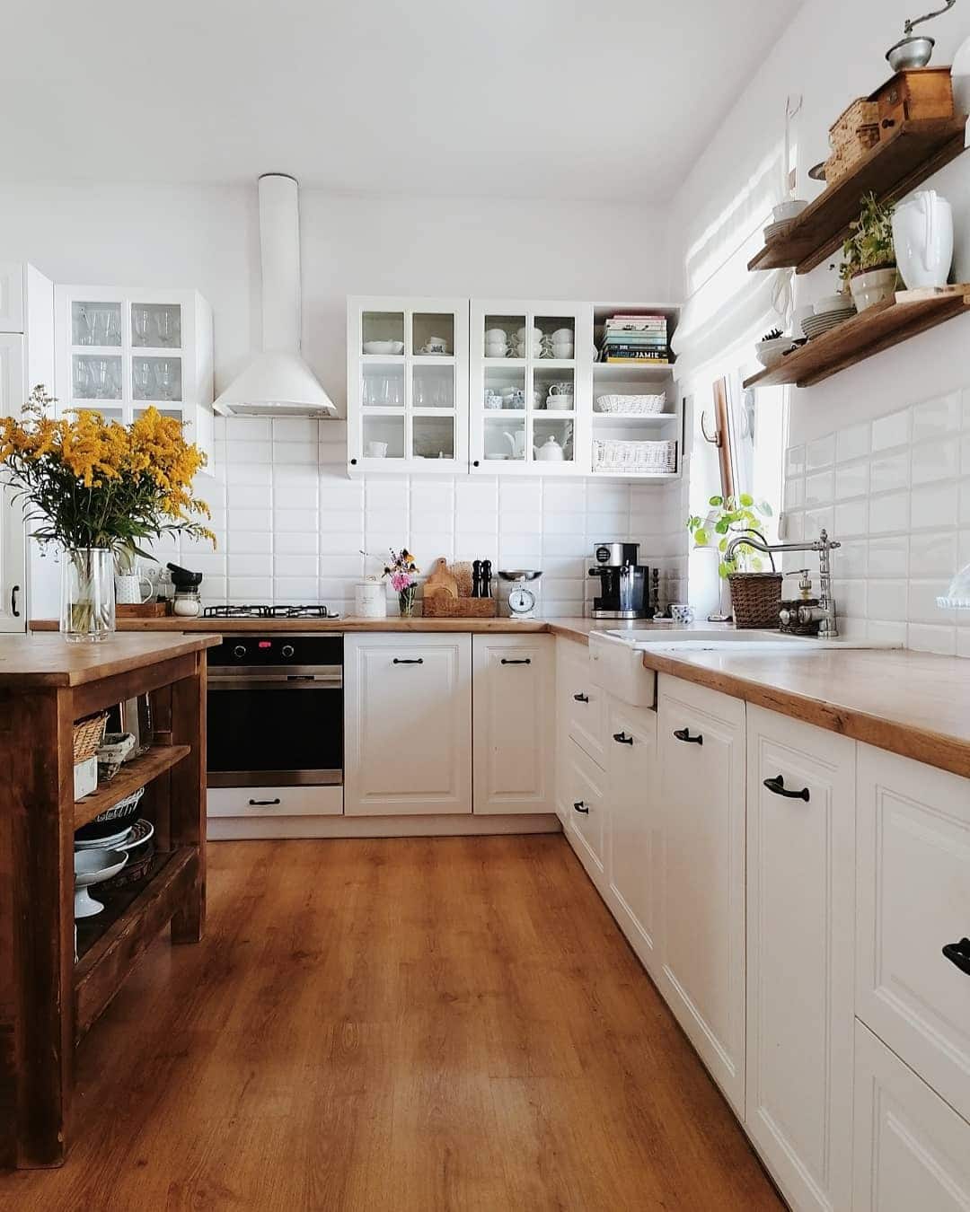6. Cozy Cottage White Kitchen With Rustic Wood Details - white kitchen ideas