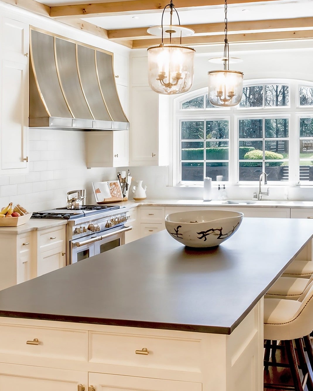 8. Elegant White Kitchen With Statement Range Hood - white kitchen ideas