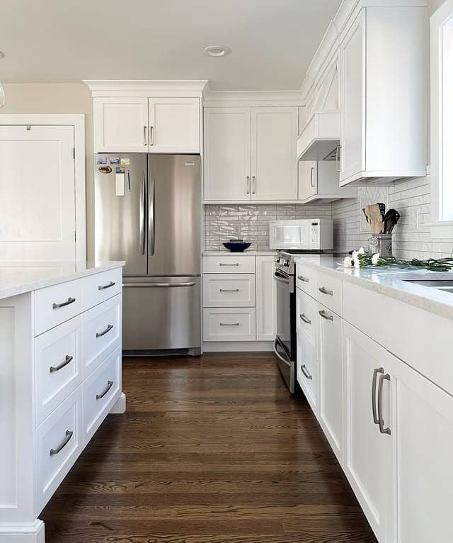 9. Classic White Kitchen With Dark Hardwood Floors - white kitchen ideas