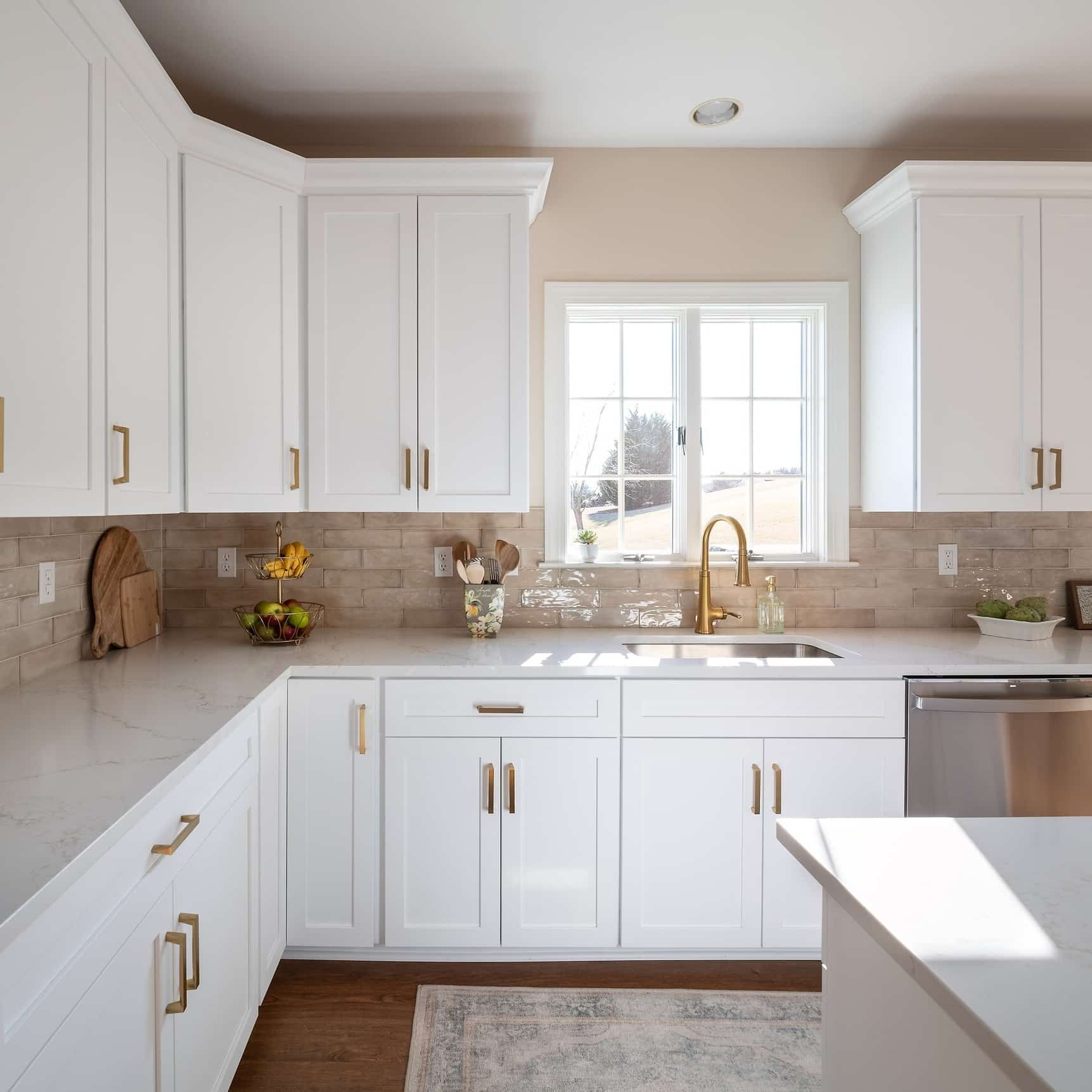 22. Warm White Kitchen With Brass Hardware - white kitchen ideas