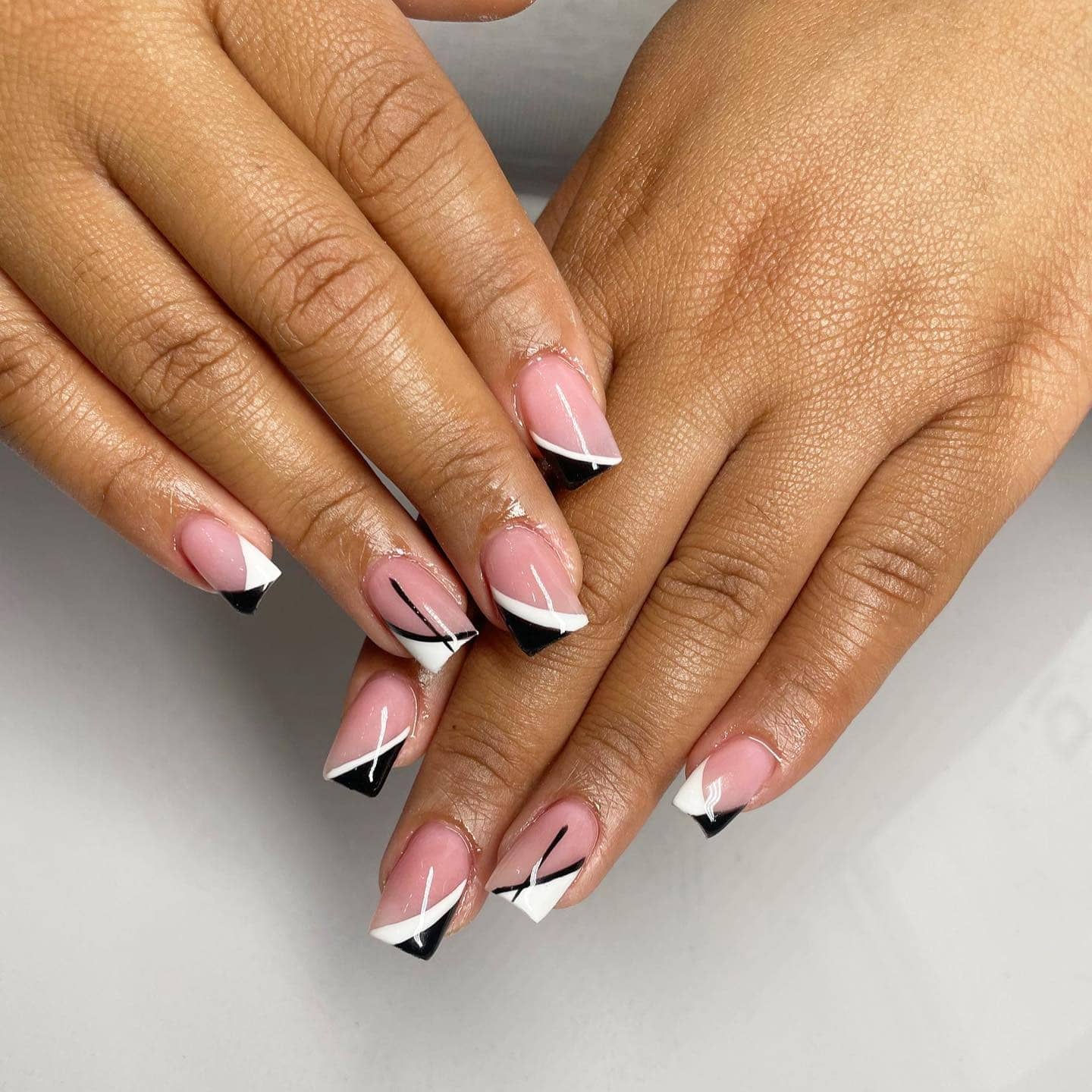 3. Minimal Black and White Diagonal French Nails - black and white nail ideas