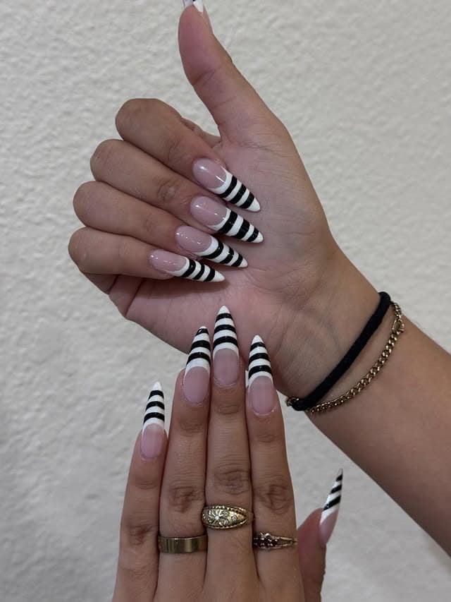 16. Black and White Striped Stiletto Nails - black and white nail ideas