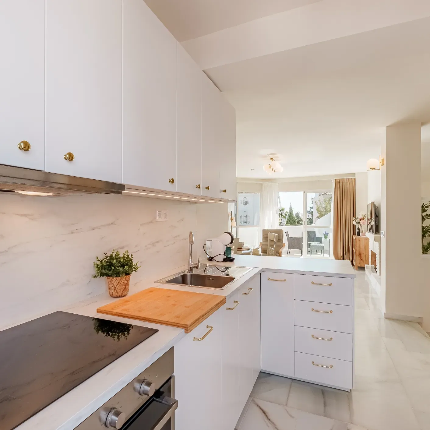 4. Minimal White Kitchen With Gold Cabinet Pulls - white and gold kitchen ideas
