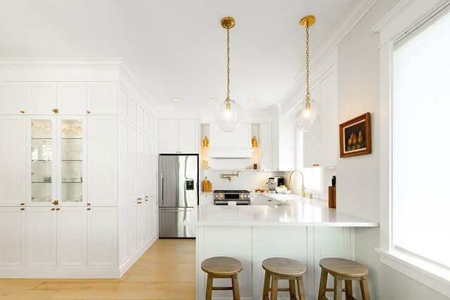 5. Bright White Kitchen With Gold Globe Pendants - white and gold kitchen ideas