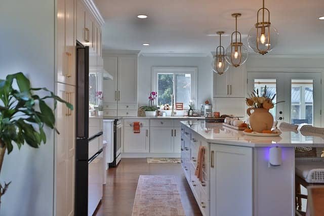 13. White Kitchen With Glass Globe Pendant Lighting - white and gold kitchen ideas