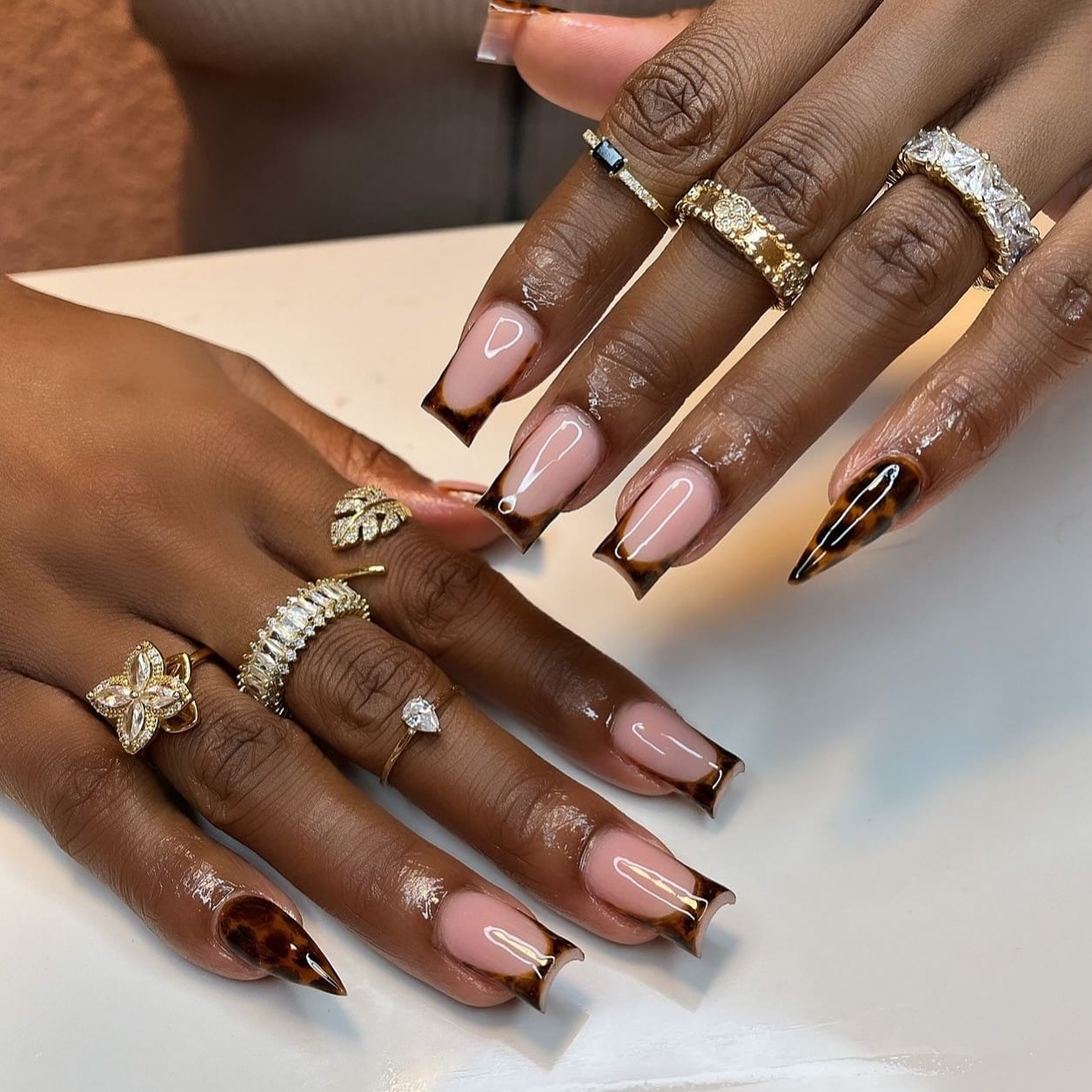 1. Glossy Tortoiseshell French Tip Nails - cheetah nail ideas