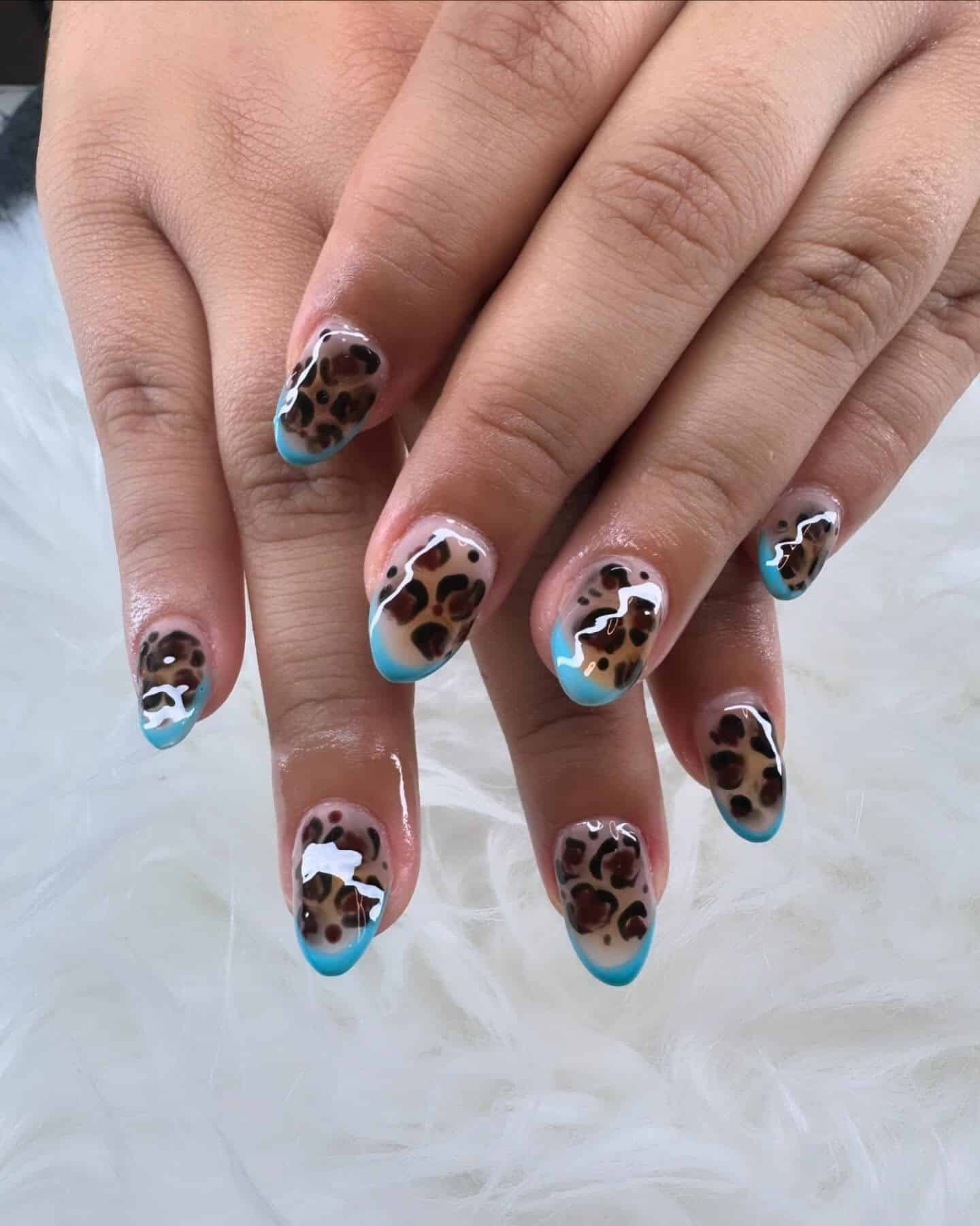 3. Blue Leopard Aura Almond Nails - cheetah nail ideas
