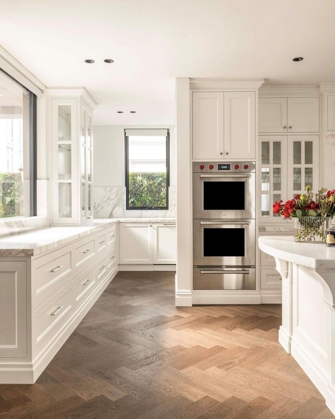 5. Warm White Kitchen with Chevron Wood Flooring - traditional kitchen ideas