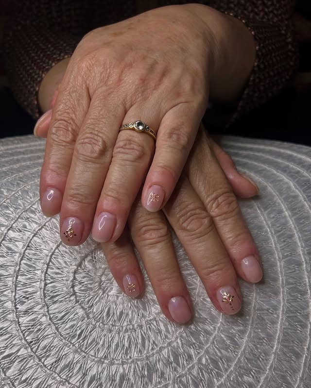 9. Sheer Pink Short Nails with Gold Leaf Accents - classy short nail ideas