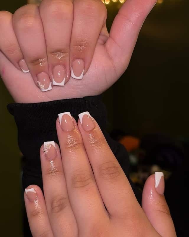 20. White French Tip Nails with Floral Accents - classy short nail ideas