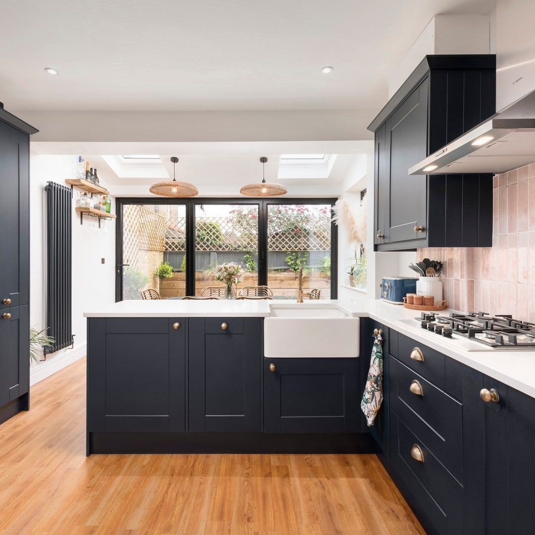 15. Cozy Navy Blue Kitchen With Blush Tile Accents - navy blue kitchen ideas