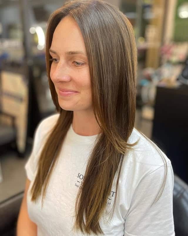 20. Sleek Mocha Long Layers with Soft Curtain Bangs - Long Shaggy Hair