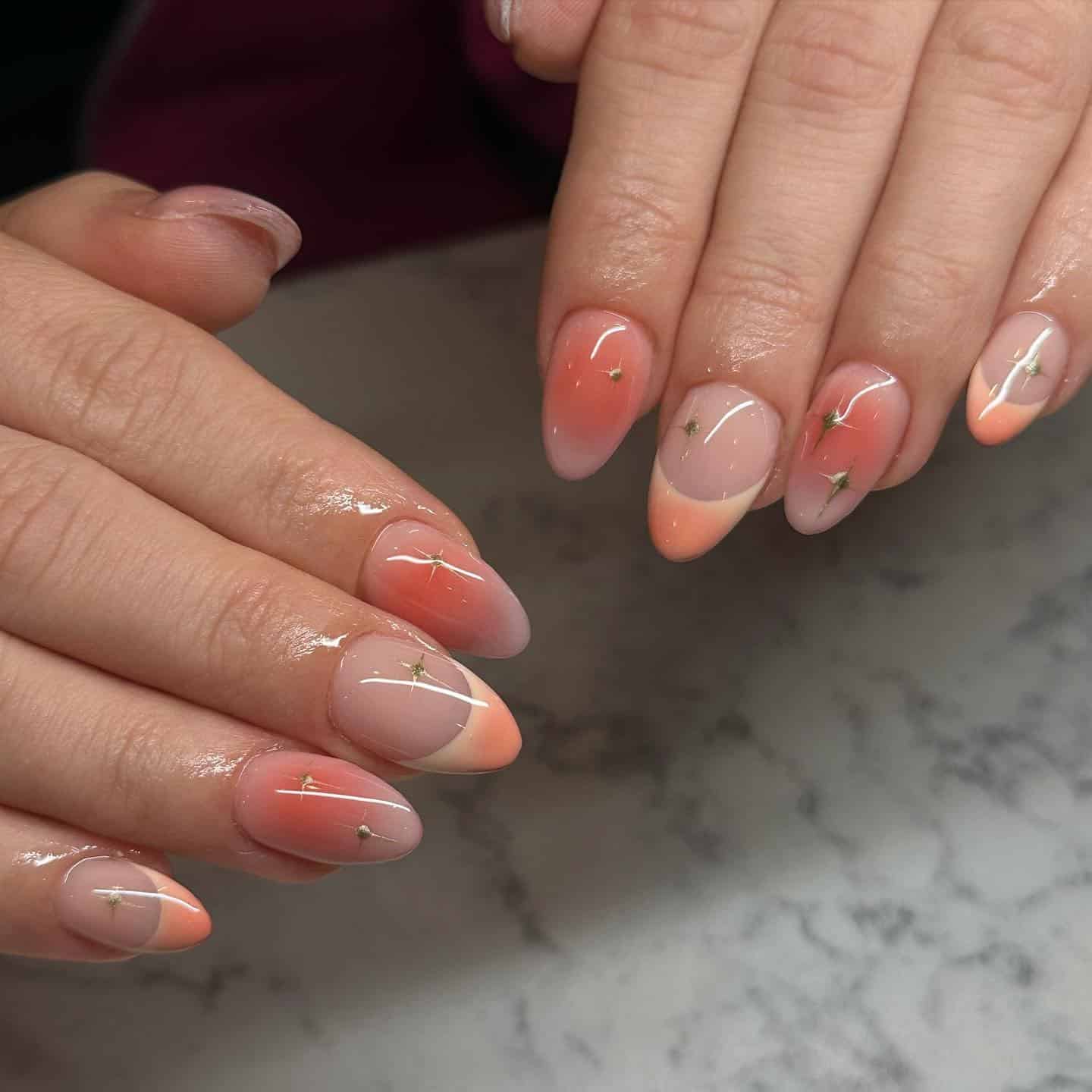 15. Peach Ombre Starburst Almond Nails - short thanksgiving nail ideas