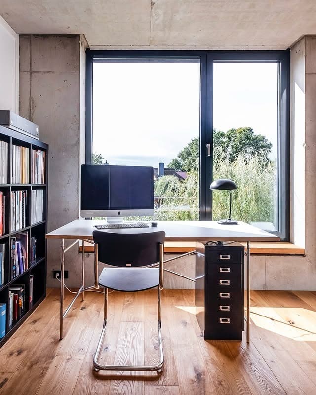 10. Industrial Minimalist Office with Floor-to-Ceiling Windows - minimalist home office ideas